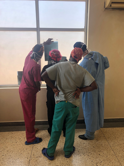 All-Hands-On-Deck-Looking-at-xray-Uganda-Spine-Surgery-Mission-2019-Day7