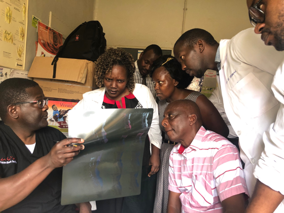 Dr-Kayanja-Talking-with-patients-Uganda-Spine-Surgery-Mission-day4-2019
