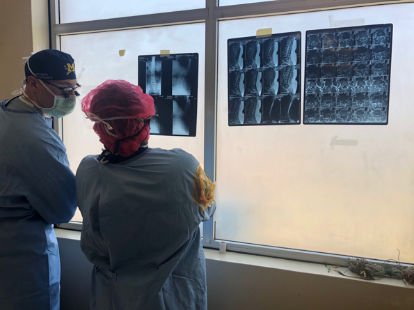 Dr-Kayanja-and-Dr-Schaffer-Looking-at-xray-on-windo-Uganda-Spine-Surgery-Mission-2019-Day7