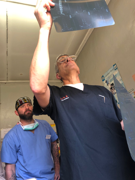 Dr-Lieberman-and-Jason-Ash-looking-over-a-patient-xray-Uganda-Spine-Surgery-Mission-2019-day11