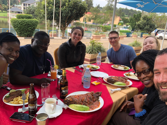 Dr-Mark-Kayanja-and-the-Uganda-Spine-Surgery-Mission-Team-Eating-Dinner-Day3-2019