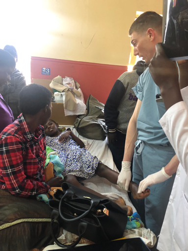 Dr-Schaffer-performing-an-exam-Uganda-Spine-Surgery-Mission-2019-Day12
