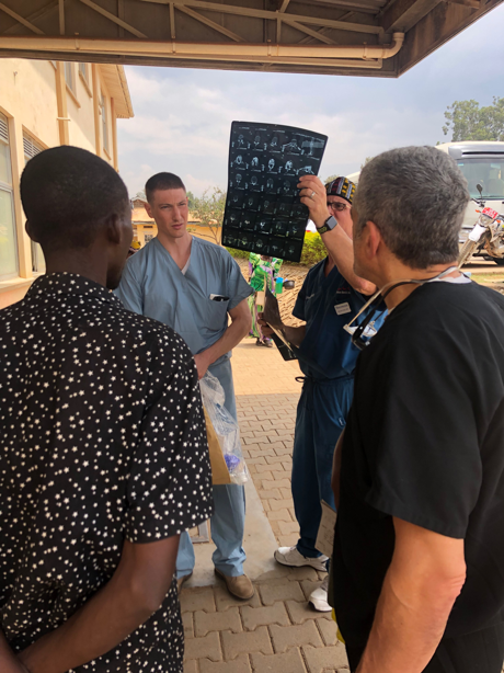Drs-Lieberman-Hisey-and-Schaffer-looking-at-the-xrays-Uganda-Spine-Surgery-Mission-Day9-10