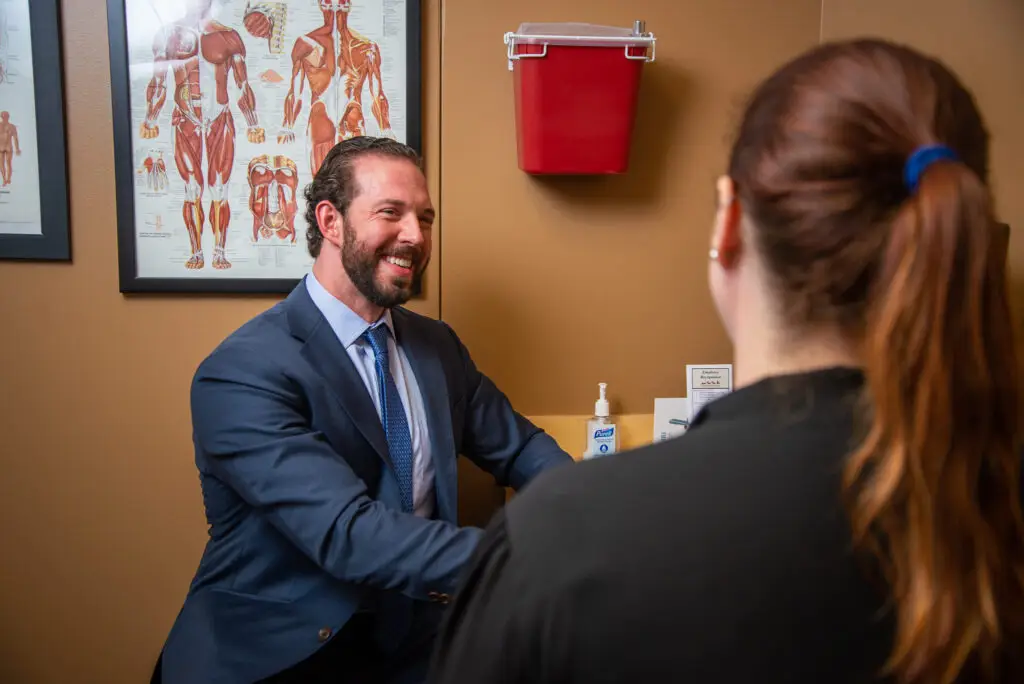 Dr Kosztowski speaking with patient