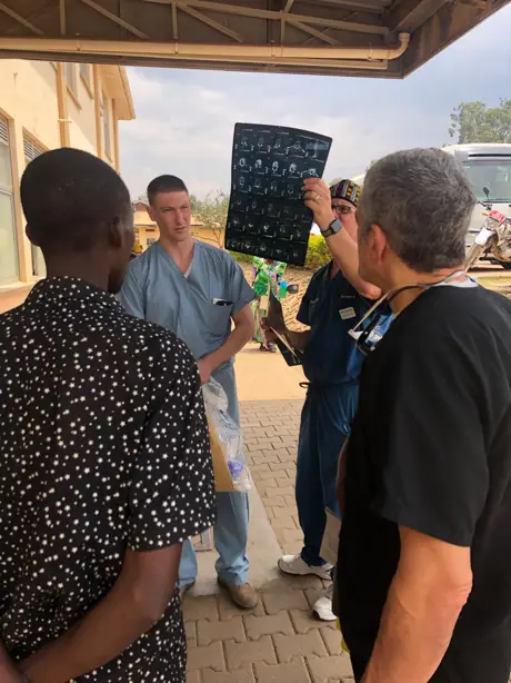 Drs-Lieberman-Hisey-and-Schaffer-looking-at-the-xrays-Uganda-Spine-Surgery-Mission-Day9-10