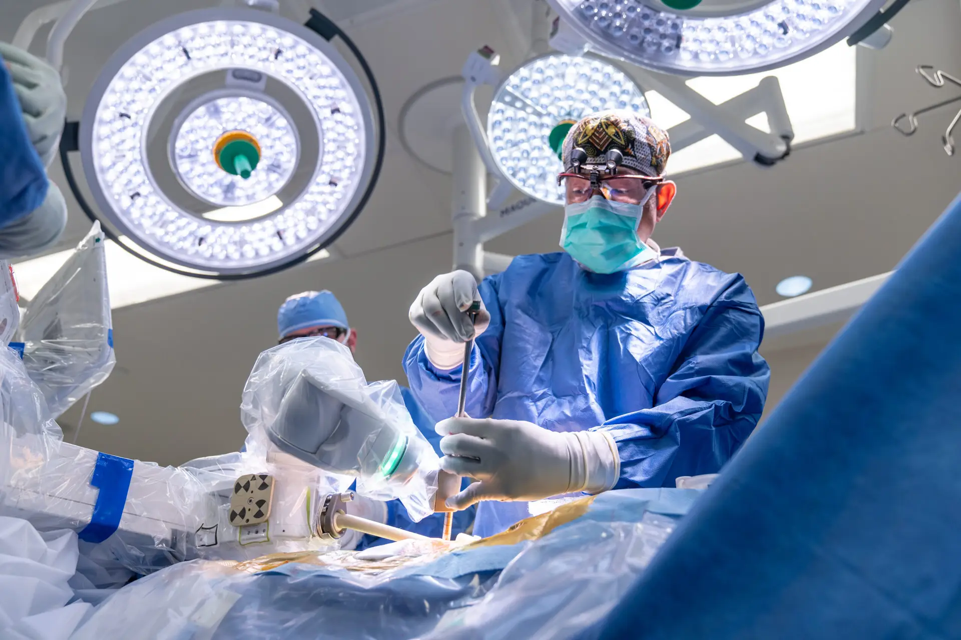 Spine surgeon performing surgery with robotics
