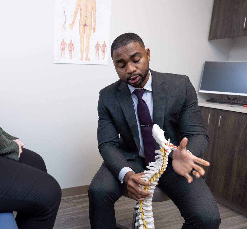 Texas Back Institute Dr. Uche Davidson and spine model